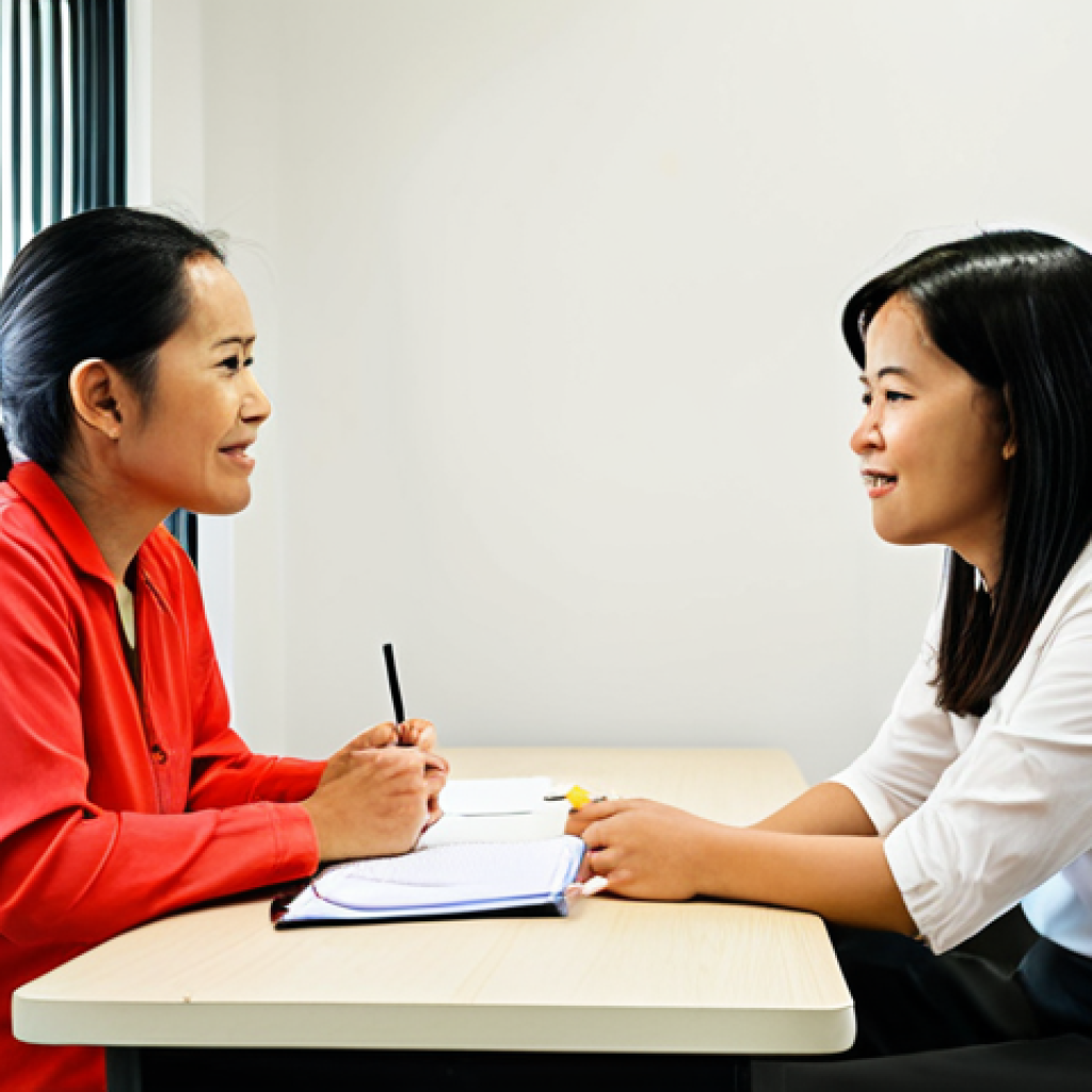 **Image Prompt:** A rehabilitation counselor engaging in an active listening session with an OKU client in a brightly lit office. Show empathy, open communication, and a supportive environment. The counselor should be taking notes. The client should appear hopeful and engaged in the session. The scene should reflect a modern Malaysian setting.