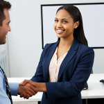 **

A confident rehabilitation counselor candidate in a professional outfit, shaking hands with a panel of interviewers. The background shows a modern office setting with diverse individuals. Emphasis on the counselor's positive body language and friendly facial expression. The scene conveys preparedness and strong communication skills.

**